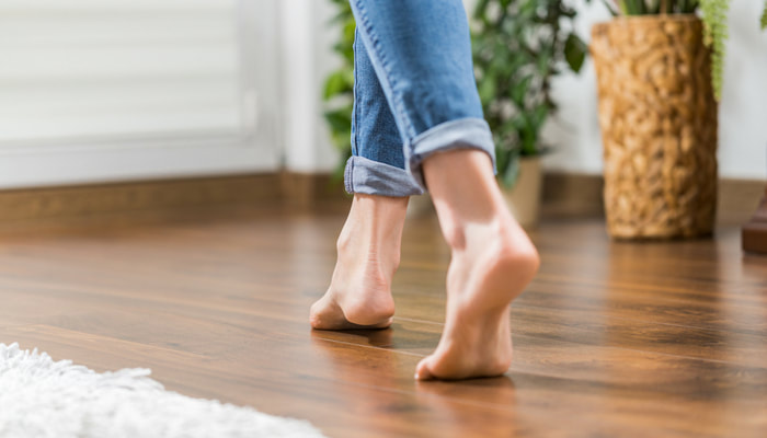 woman walking barefoot wooden floor orthotics shoes homyped posture friendlies chemist castletown townsville advice 